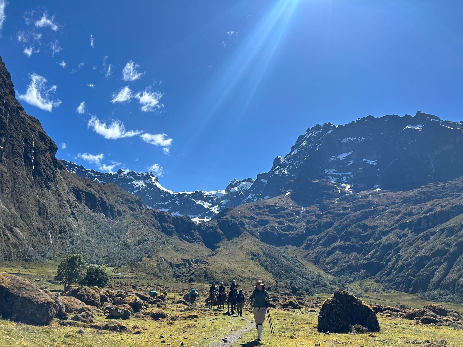 Personas recorriendo un sendero entre montañas